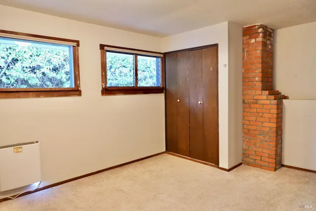 a view of empty room with floor to ceiling window