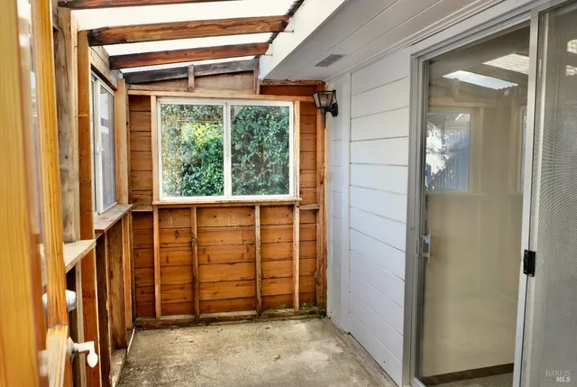a balcony with furniture and a potted plant