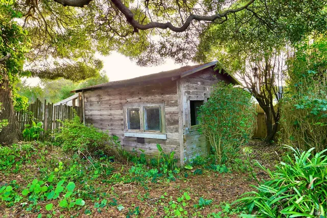 an aerial view of residential houses with outdoor space and swimming pool