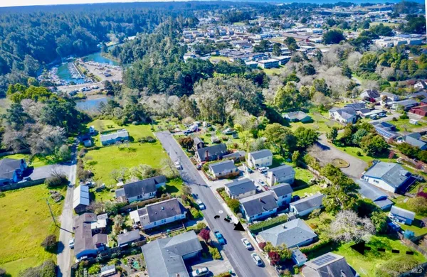 an aerial view of a houses with a yard