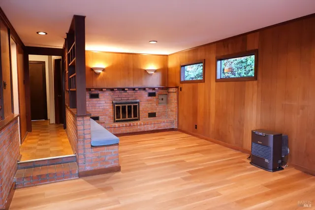 a view of a livingroom with furniture staircase and a fireplace