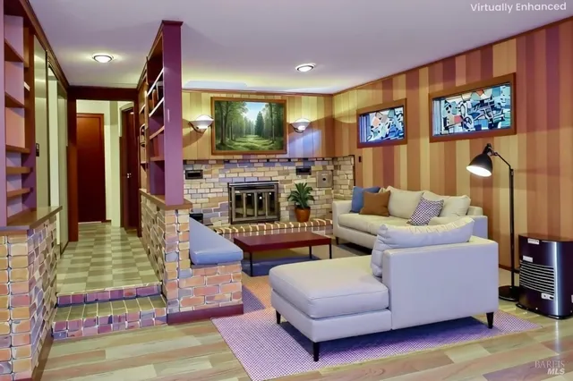 a living room with fireplace furniture and a flat screen tv