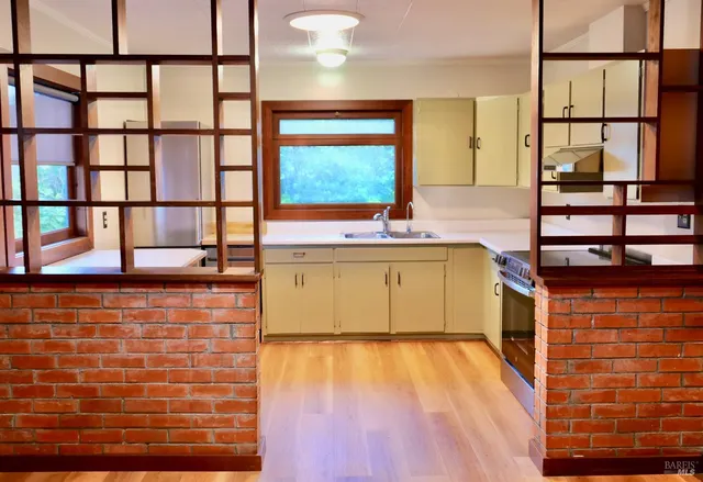a kitchen with a sink and cabinets