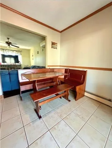 a room with furniture and view of kitchen
