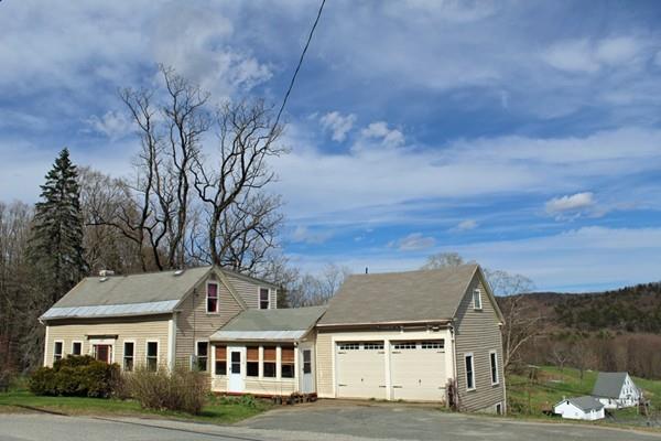 859 Greenfield Road Leyden, MA 01337 - Photo 1 of 42 a front view of residential houses with yard and mountain view in back