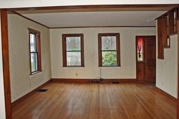 859 Greenfield Road Leyden, MA 01337 - Photo 17 of 42 an empty room with wooden floor and windows