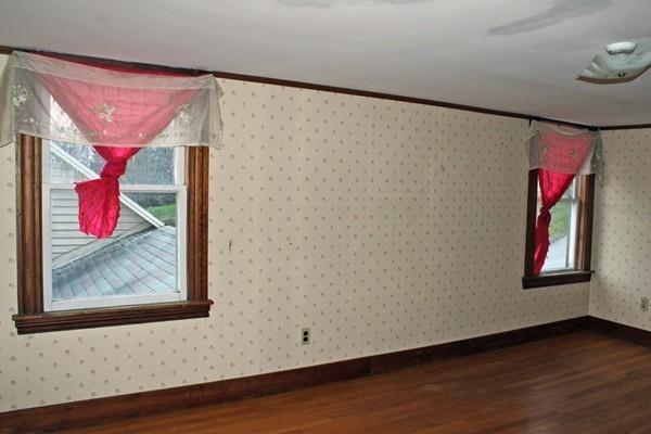 859 Greenfield Road Leyden, MA 01337 - Photo 23 of 42 a view of a hallway with paintings on the wall and a window