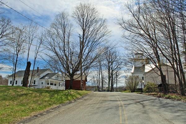 859 Greenfield Road Leyden, MA 01337 - Photo 41 of 42 a front view of a house with a yard and garage