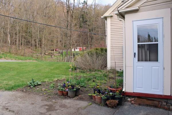 859 Greenfield Road Leyden, MA 01337 - Photo 5 of 42 a view of a backyard with plants and a garden
