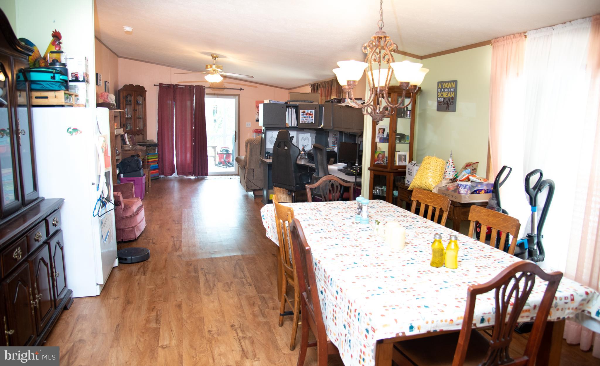 104 Raptor Drive Hanover, PA 17331 - Photo 19 of 30 a dining room with furniture a chandelier and wooden floor