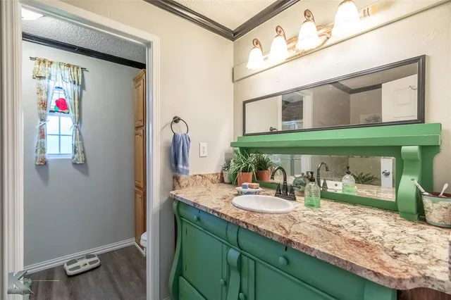 a view of a workspace room with wooden floor windows and closet
