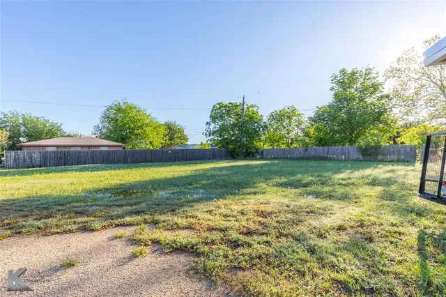 a bathroom with a granite countertop toilet sink mirror vanity and shower