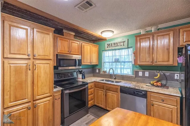 a kitchen with a refrigerator stove and sink