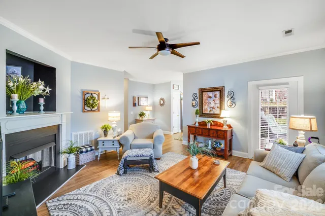 a living room with furniture a fireplace and a window
