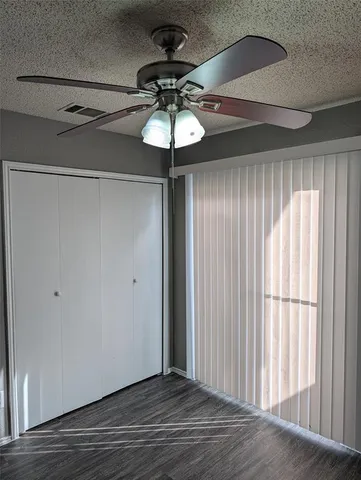 a view of a chandelier fan and wooden floor in a room
