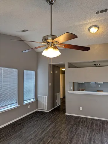 a view of a room with wooden floor