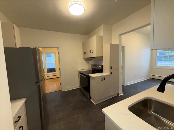 a kitchen with stainless steel appliances a refrigerator sink and stove