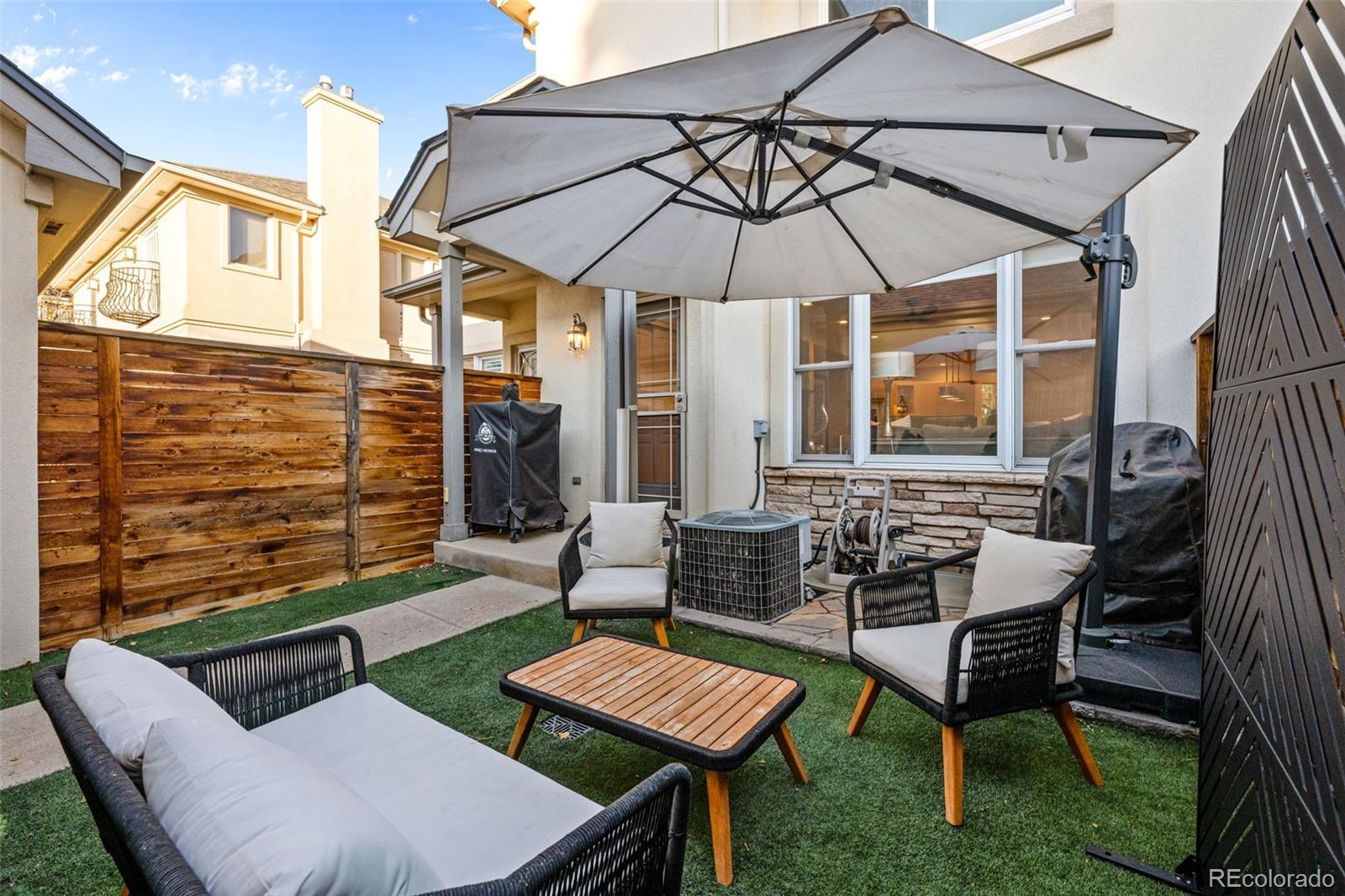 83 South Monroe Street Denver, CO 80209 - Photo 11 of 19 a patio with a table and chairs under an umbrella