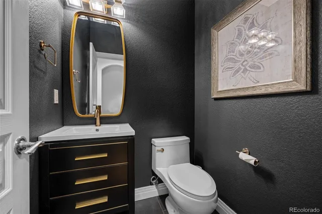 a bathroom with a toilet a sink and mirror