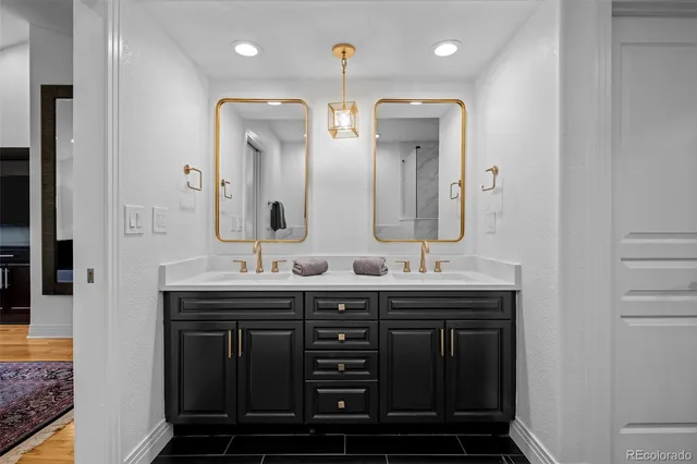 a bathroom with double sink and a mirror