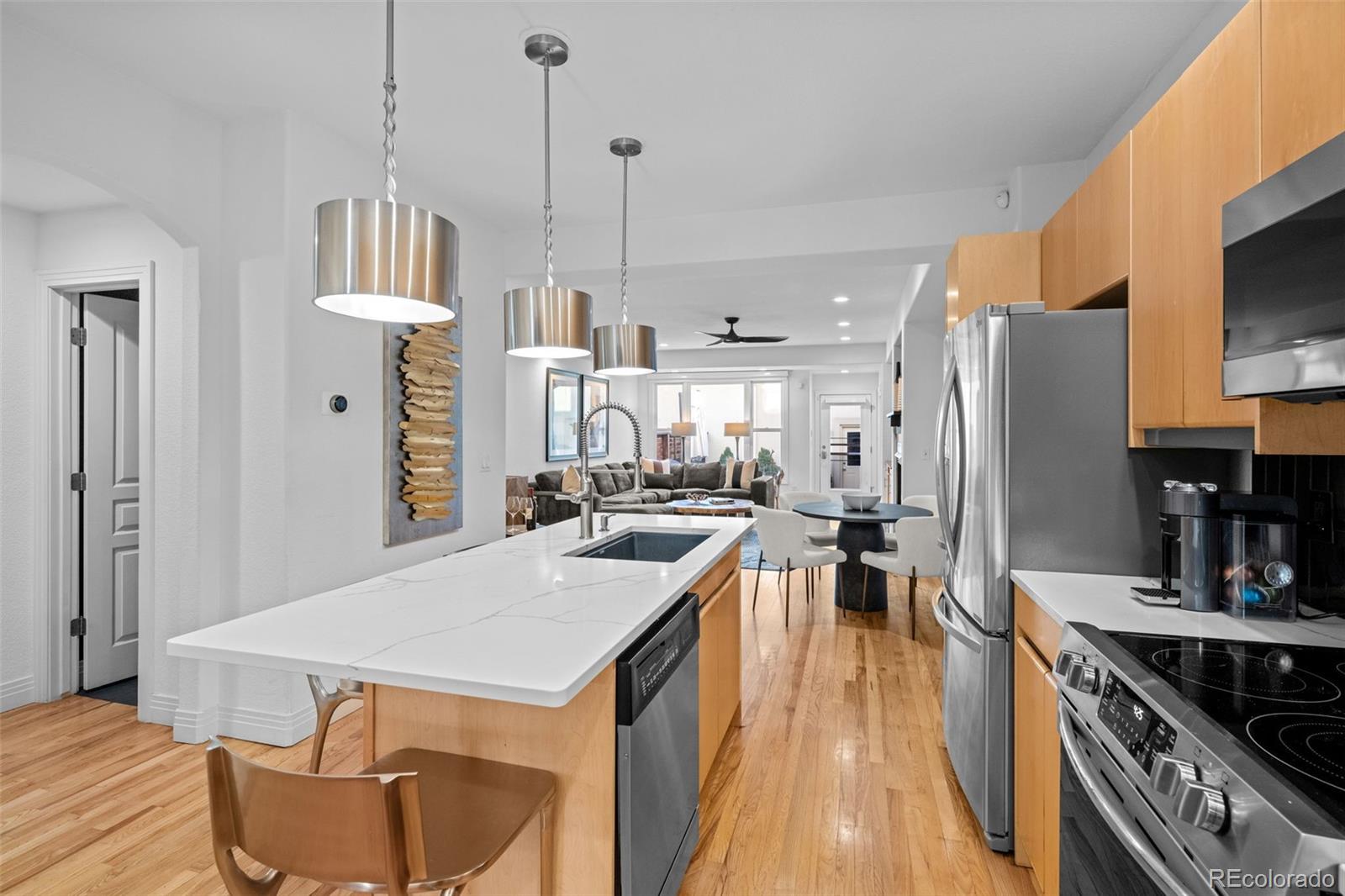 83 South Monroe Street Denver, CO 80209 - Photo 7 of 19 a kitchen with a table chairs refrigerator and microwave