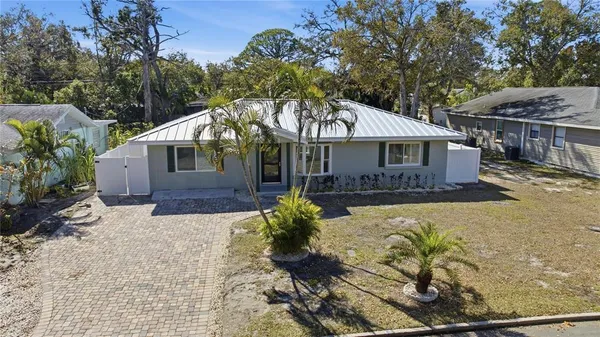 a front view of a house with a yard and a garden