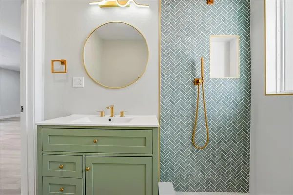 a bathroom with a sink a toilet and a mirror