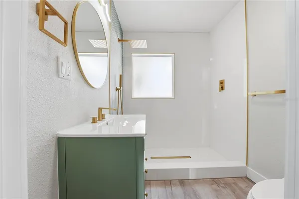 a bathroom with a sink a toilet and a mirror