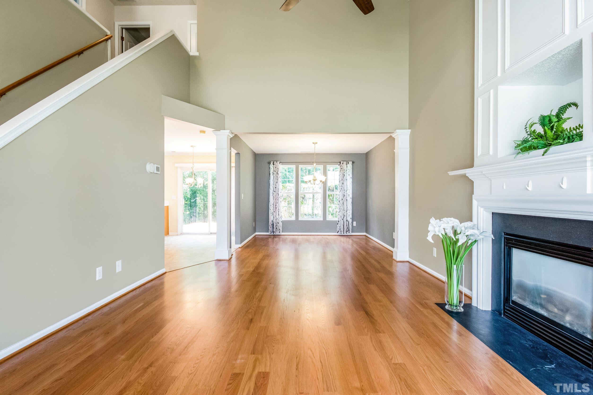 4827 Shallowbrook Trail Raleigh, NC 27616 - Photo 3 of 30 a view of an empty room with wooden floor and a window