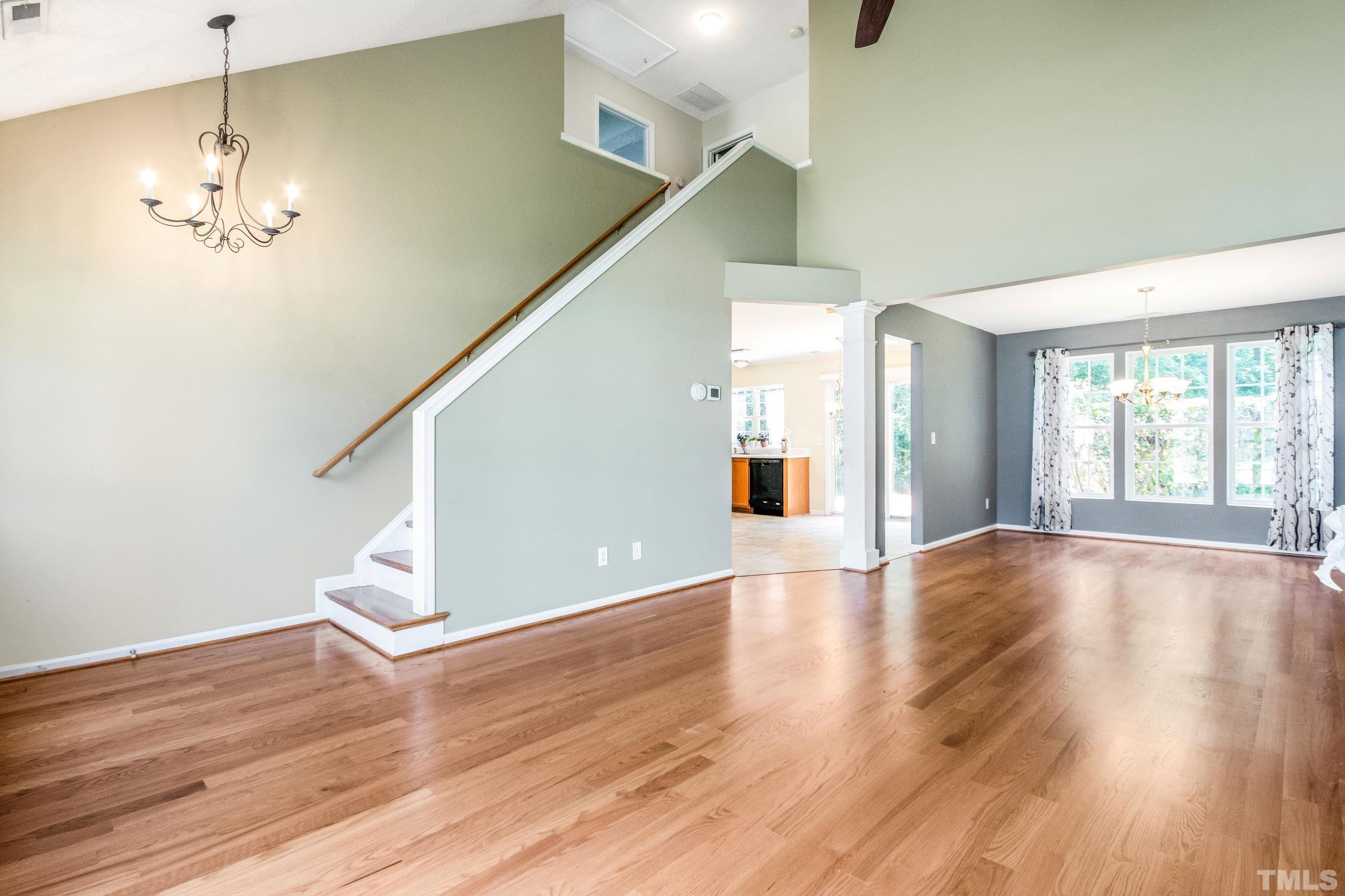 4827 Shallowbrook Trail Raleigh, NC 27616 - Photo 4 of 30 a view of an empty room with wooden floor and a window