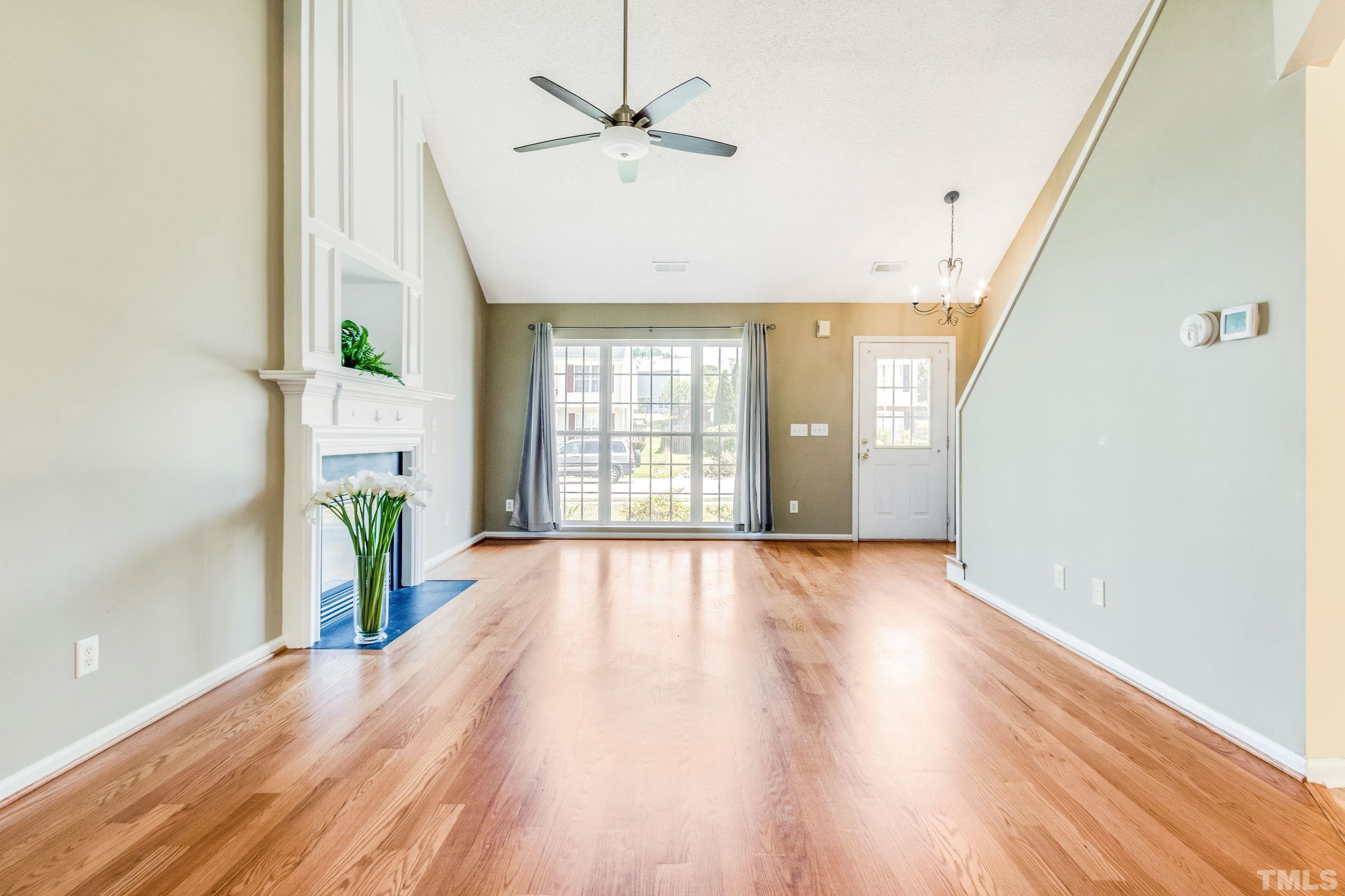 4827 Shallowbrook Trail Raleigh, NC 27616 - Photo 5 of 30 a view of an empty room with wooden floor and a window