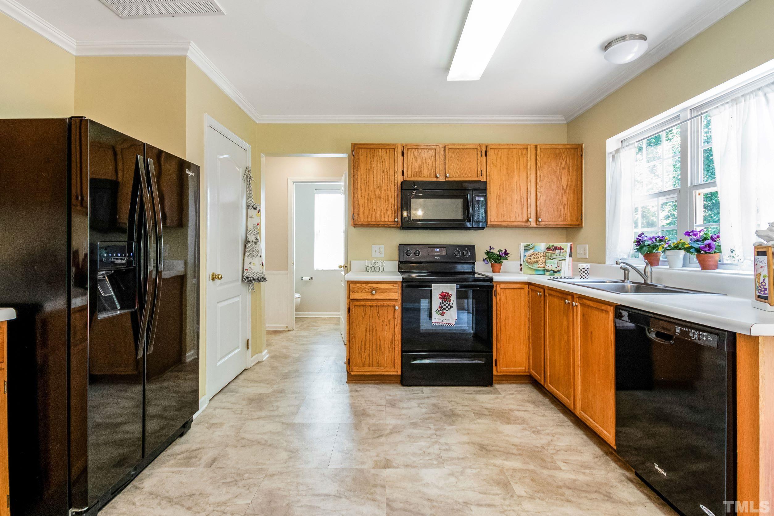 4827 Shallowbrook Trail Raleigh, NC 27616 - Photo 9 of 30 a kitchen with stainless steel appliances a refrigerator sink and microwave