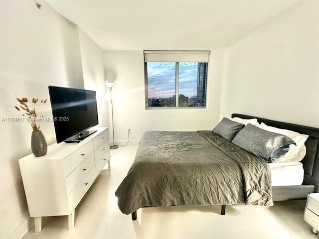 92 Southwest 3rd Street, Unit 1410 Miami, FL 33130 - Photo 11 of 40 a bedroom with a bed and a flat screen tv