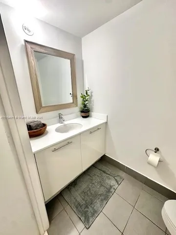 a bathroom with a toilet and a mirror