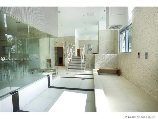 a bedroom with furniture and a floor to ceiling window