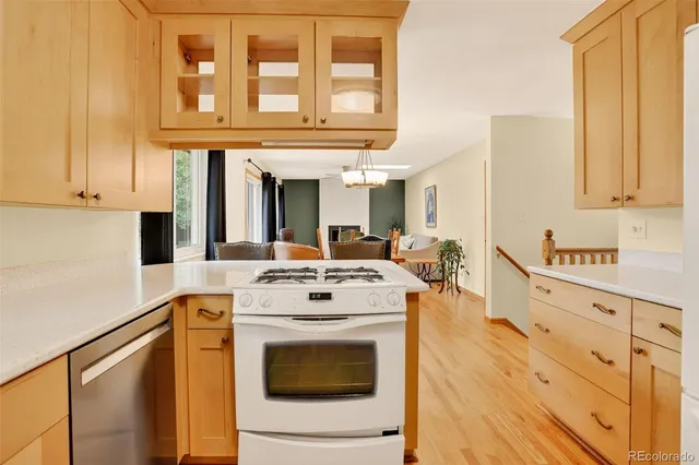 a kitchen with stainless steel appliances granite countertop a stove and a white cabinets