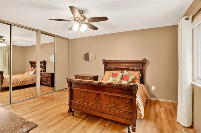 a bedroom with furniture and a mirror