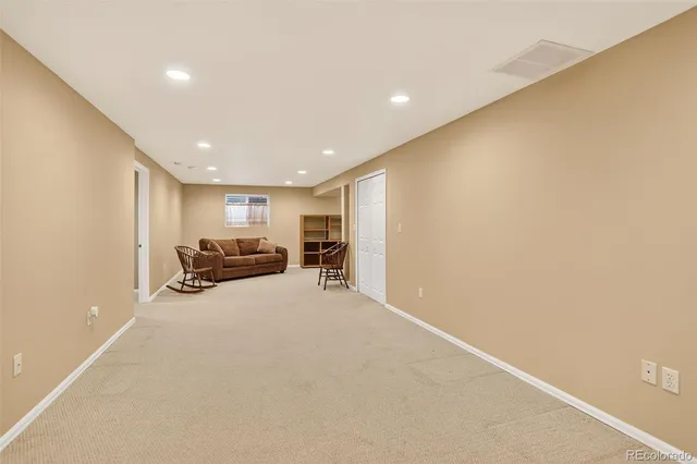 a view of a livingroom with furniture and a ceiling fan