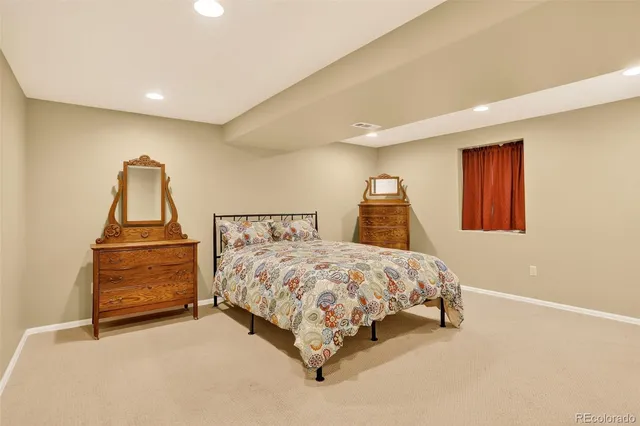 a bedroom with a bed and a dresser