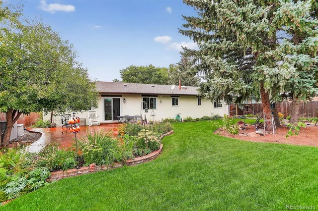 a front view of house with a garden and patio