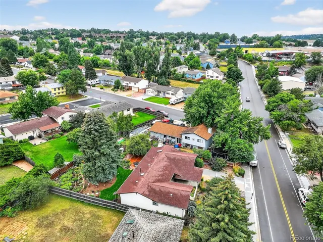 an aerial view of residential houses with outdoor space and swimming pool