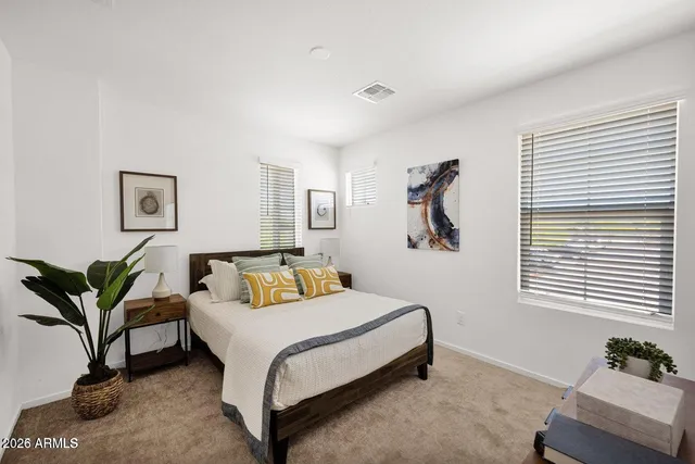 a bedroom with a bed couch and a window