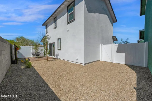 a view of a house with a backyard
