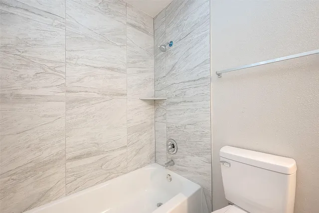 a bathroom with a bathtub and a toilet