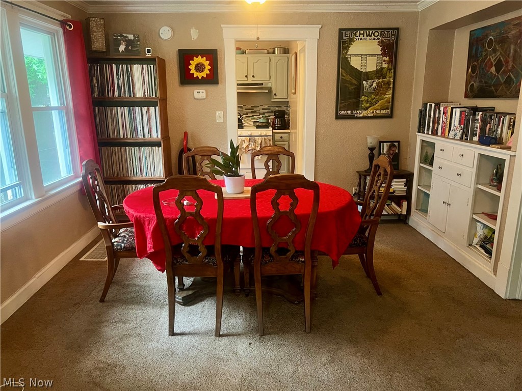 1714 Hillview Road Cleveland, OH 44112 - Photo 5 of 17 Carpeted dining space with crown molding