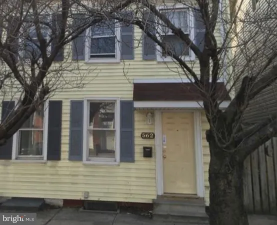a view of a house with a large tree