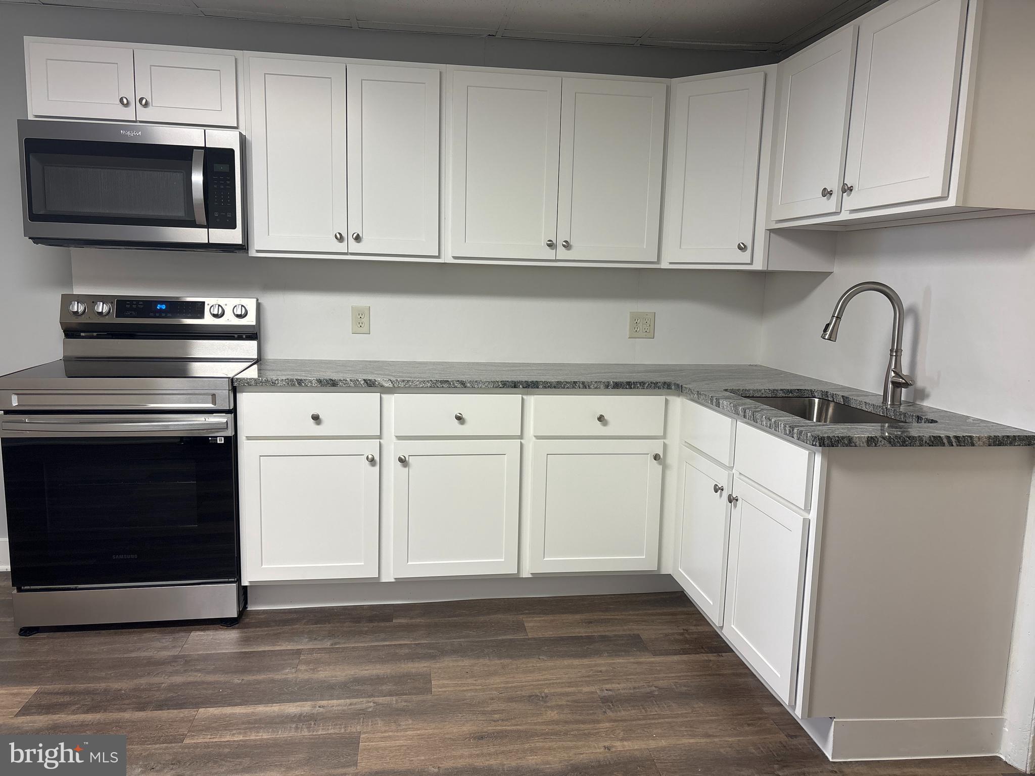 562 West Philadelphia Street York, PA 17401 - Photo 2 of 20 a kitchen with granite countertop white cabinets and stainless steel appliances