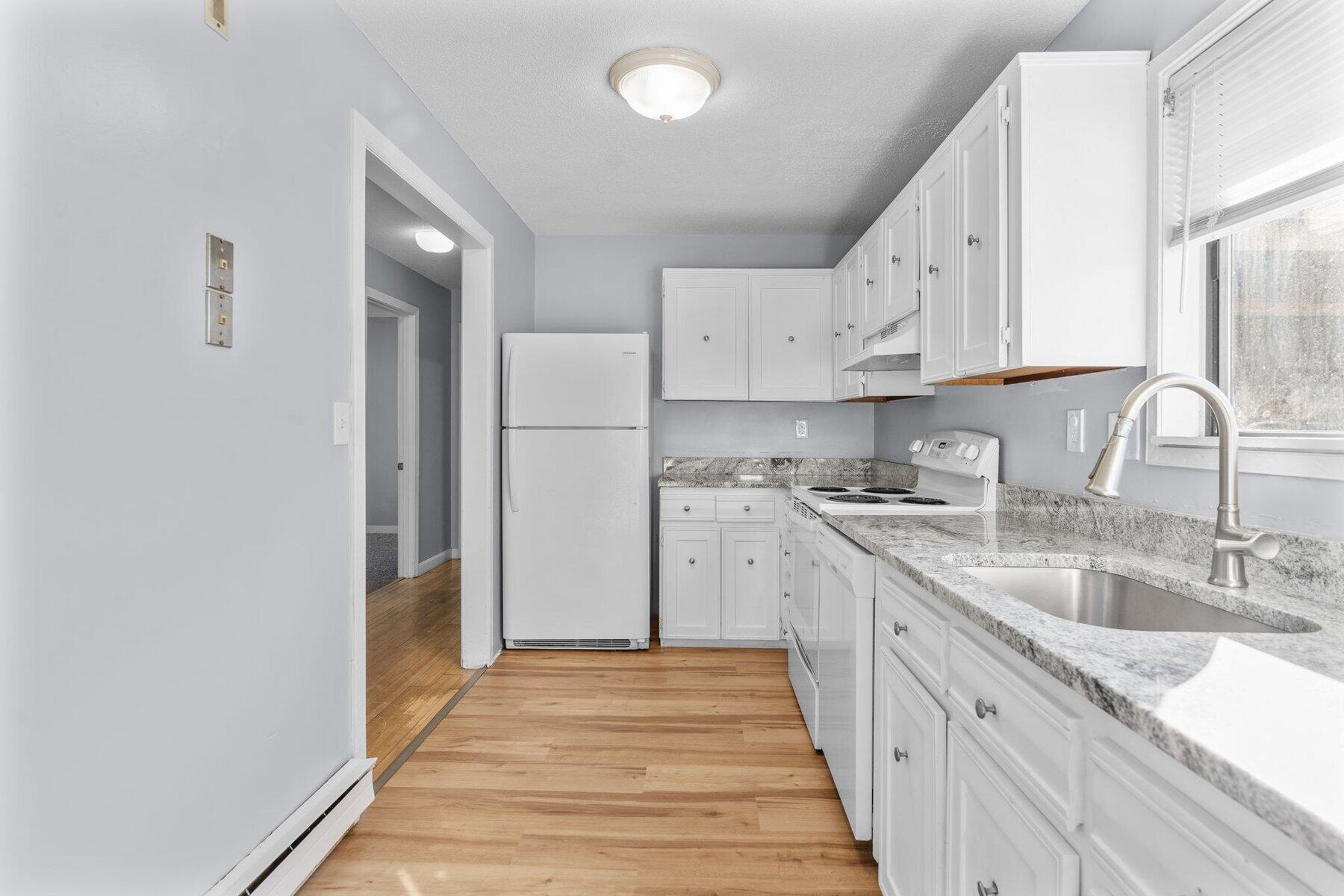 800 Bearses Way, Unit 3NF Hyannis, MA 02601 - Photo 14 of 28 a kitchen with granite countertop white cabinets and white appliances