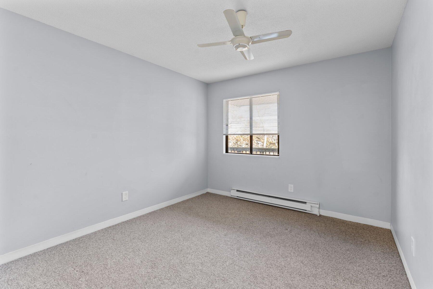 800 Bearses Way, Unit 3NF Hyannis, MA 02601 - Photo 17 of 28 an empty room with a chandelier fan and windows