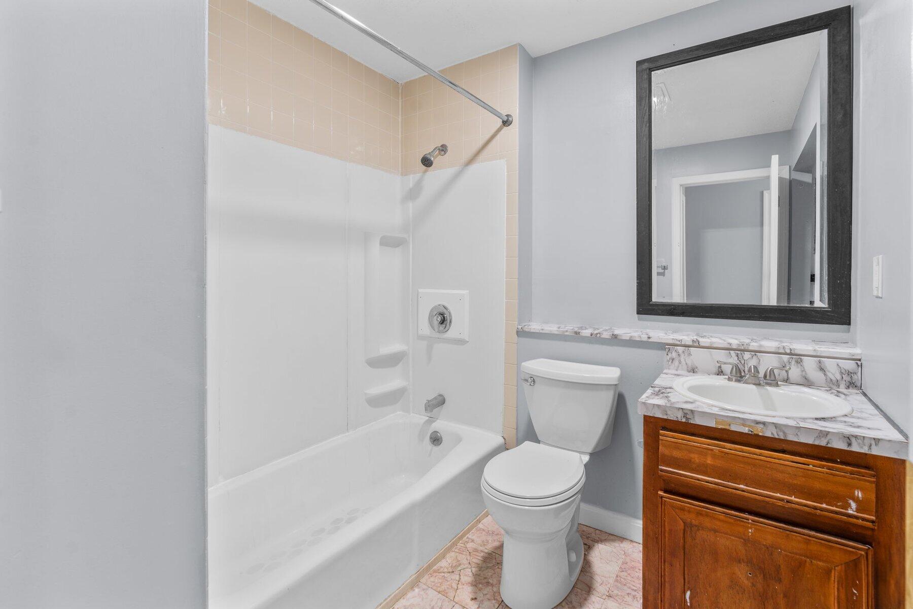 800 Bearses Way, Unit 3NF Hyannis, MA 02601 - Photo 21 of 28 a bathroom with a toilet sink vanity tub and mirror